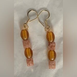 Vintage amber glass beads & hand painted beads crafted into earrings. Hang 2.25”
